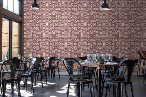 Glyph Nazca earth toned patterned designer wallpaper in a restaurant interior