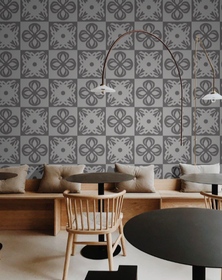 Alternating light and dark grey chequred large patterned wallpaper in a coffee shop interior