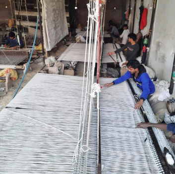 Artisans in India making rugs