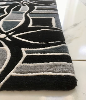 Close up view of the corner of the BLOK Comic Noir rug