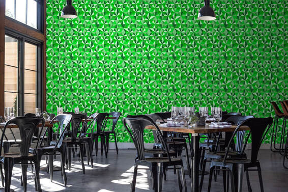 Green toned Jewel Emerald geometric patterned wallpaper on a wall in a golf clubhouse restaurant interior