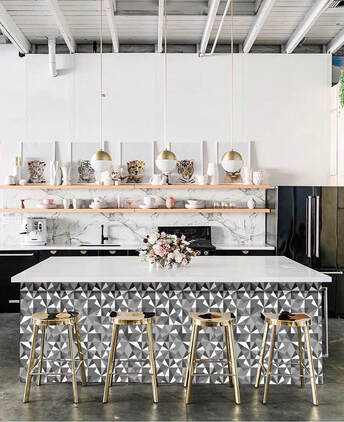 Jewel Diamond geometric patterned wallpaper in shades of grey on the side of a kitchen island in a kitchen interior