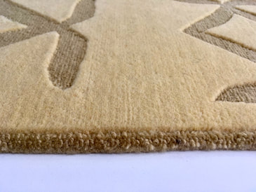The Glyph Giza luxury designer rug has a contrasting texture of a higher cut pile against a patterened lower loop pile