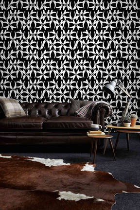 173NASH Icon black and white patterned wallpaper behind a brown leather couch on a wall in an interior