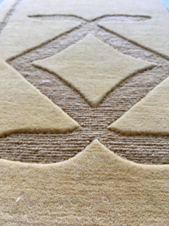 Close up view of the Glyph Giza luxury wool rug showing the detail and contrasting texture of the higher cut pile against the lower loop pile