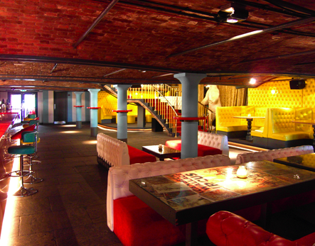 Colourful interior with table graphics and a brick vaulted ceiling in a bar and nightclub interior in Liverpool
