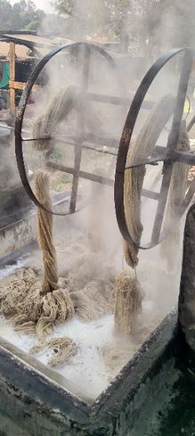 Rug yarns getting spun through large wheels and being washed